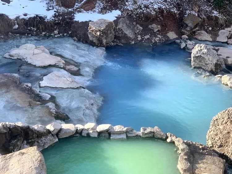 Turquoise blue pools at Fifth Water Hot Springs in Diamond Fork Canyon Utah with warm waterfall cascading over mineral deposits